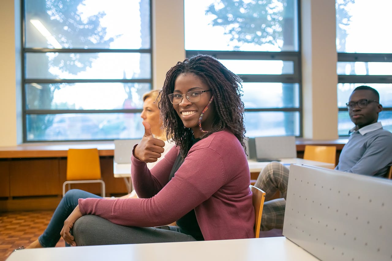 Smiling students sitting in a modern classroom, showing enthusiasm and teamwork.